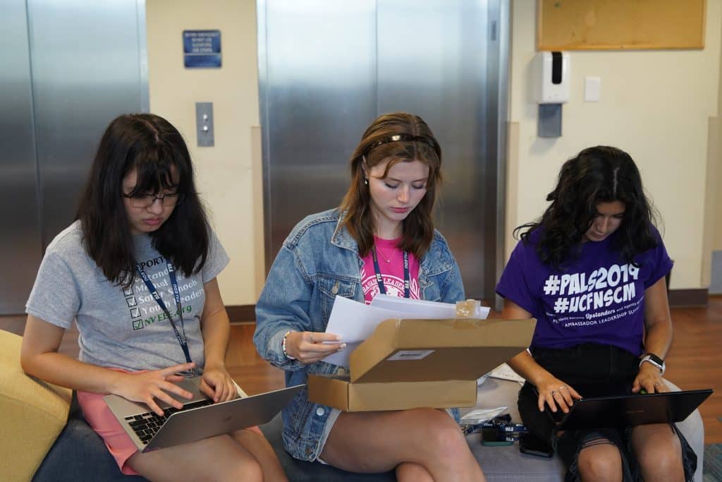 NVEEE interns working together on laptops