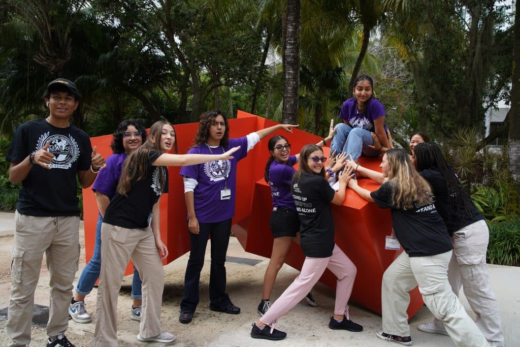 NVEEE interns and staff in purple PALS shirts on a university campus