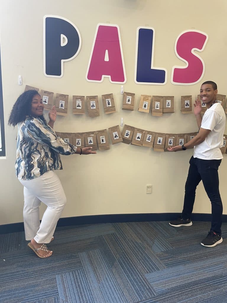 NVEEE interns hanging a PALS welcome banner