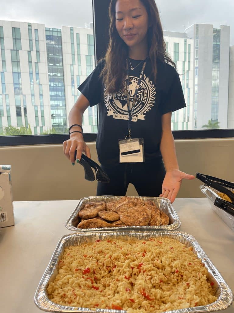 An NVEEE intern serving food at PALS