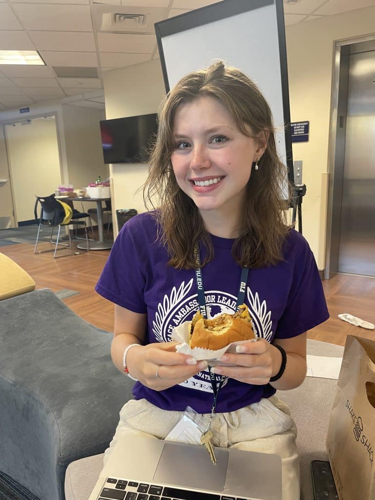Smiling NVEEE intern in a purple PALS shirt