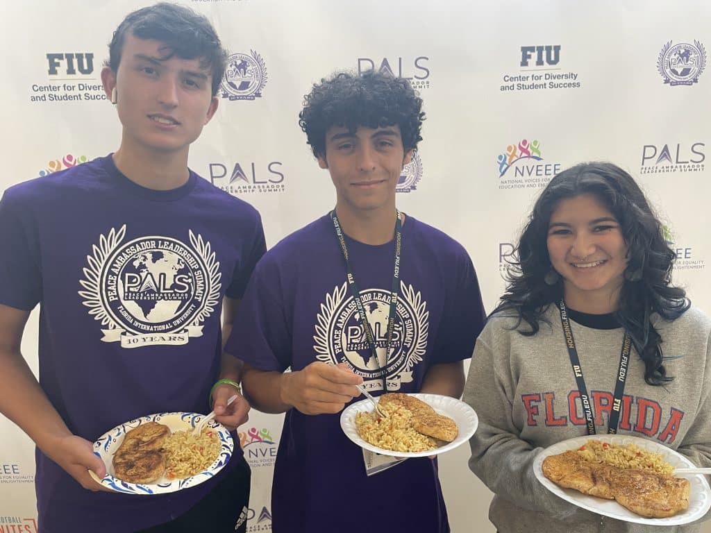Three NVEEE interns at the PALS step-and-repeat