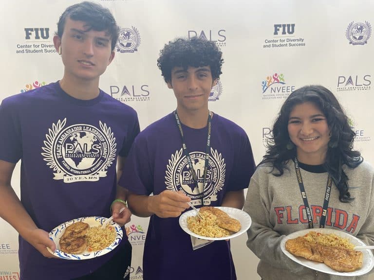 Three NVEEE interns at the PALS step-and-repeat
