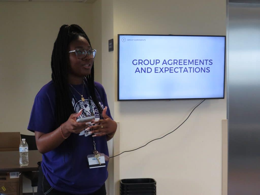 An intern presenting group agreements to students