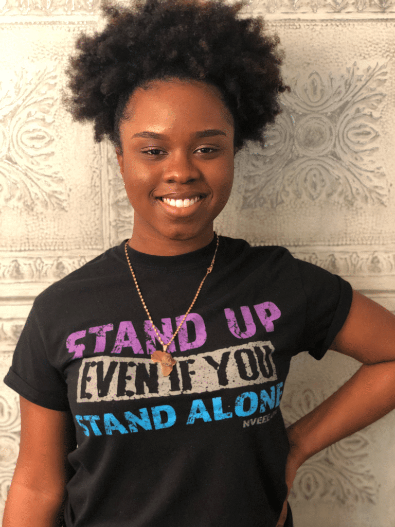 An NVEEE intern wearing a Stand Up shirt