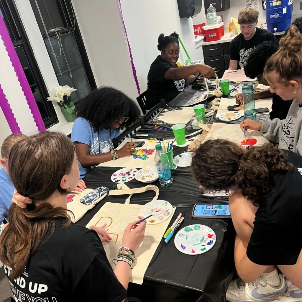 Students painting tote bags at PALS