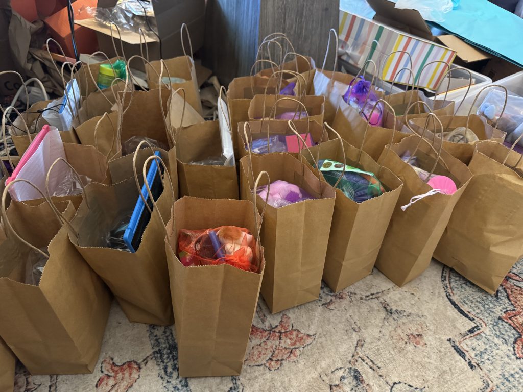 Thirty supply bags laid out for an elementary school classroom