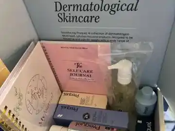 An open NVEEE self-care gift box with wellness items